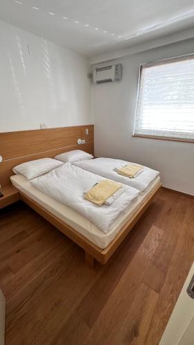 a large bed in a room with a window at Apartments Kaninska Vas in Bovec