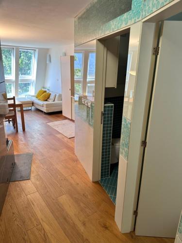 a living room with a view of a kitchen with a fireplace at Apartments Kaninska Vas in Bovec
