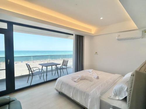 a bedroom with a bed and a view of the beach at miami costinesti in Costinesti