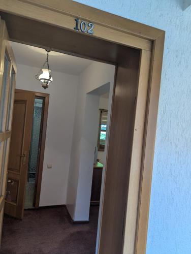 a hallway with a door with a sign on it at Vila Bârsana in Bîrsana