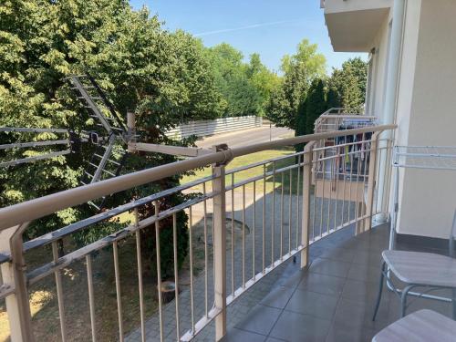 a balcony with a railing with a view at Apartman N in Pusztavacs