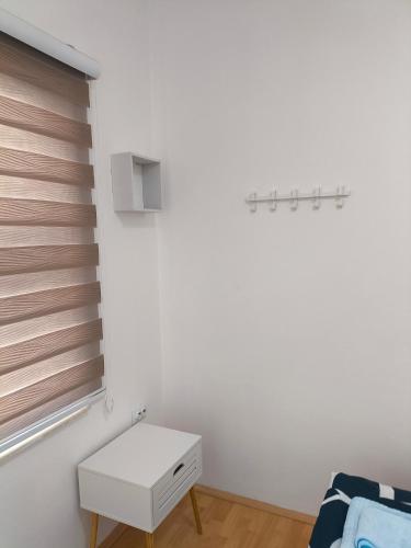 a white room with a table and a window at Zusy in Orebić