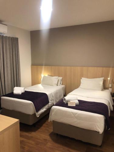 Cama o camas de una habitación en Legacy Hotel Guaratinguetá - Ao lado de Aparecida -SP