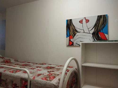 a bedroom with a bed and a painting on the wall at Lake View, Pool and Relax in a Private Villa in Pilzone