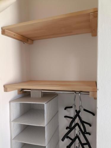 a closet with a wooden shelf and wine racks at Zusy in Orebić