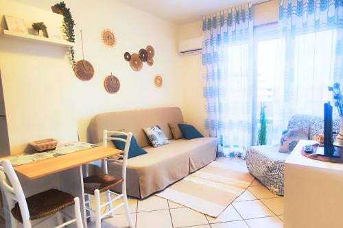 a living room with a couch and a table at Sky & Sand Apartment in Porto Santa Margherita di Caorle