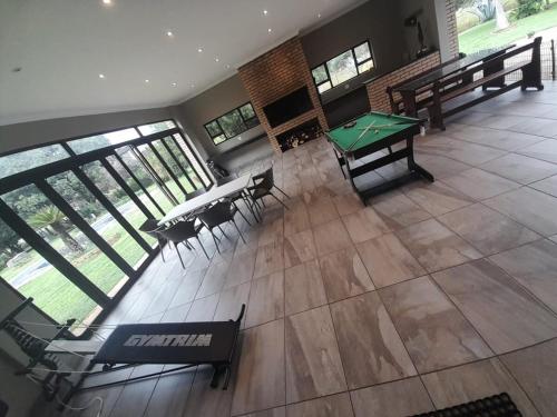 an empty room with a ping pong table and chairs at Antelope Farm Events in Pretoria