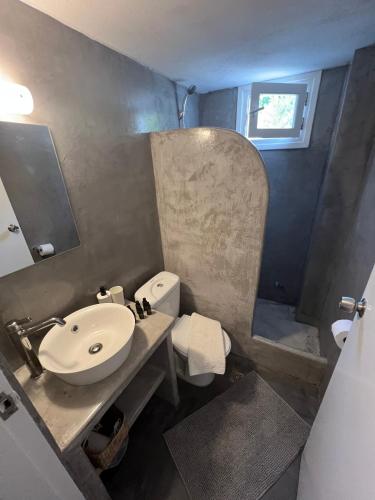 a bathroom with a sink and a toilet at Spanos Suites - Panteli in Panteli
