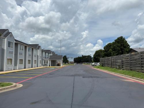 an empty street in a residential neighborhood with houses at Americas Best Value Inn and Suites Ada in Ada