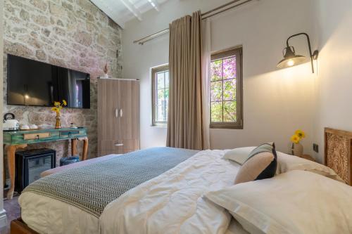 a bedroom with a large bed and a fireplace at Mediha Hanım Konağı Alaçatı in Cesme