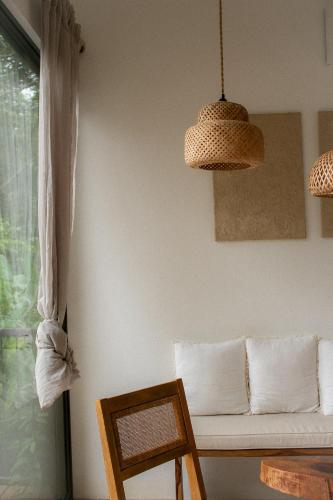 a living room with a couch and a window at Maze Lodge in Puerto Jiménez