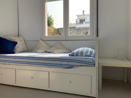 a bed in a room with two windows at Girona m'enamora in Girona