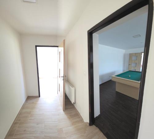 a hallway with a mirror and a pool table at Apartmány u jízdárny in Skalice