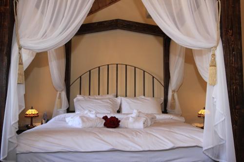 a white bed with two stuffed animals on it at The Pearl of the Golan - Pnina BaGolan in Had Nes