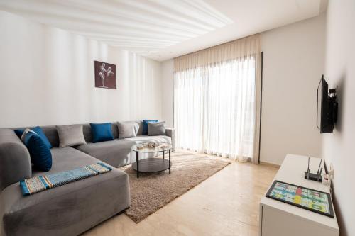 a living room with a couch and a table at Garden Bay Signature AppartHotel in Casablanca