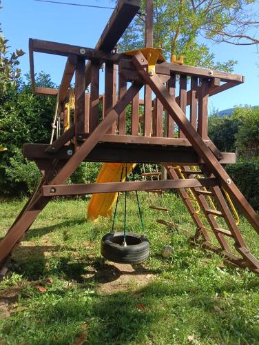 a playground with a tire swing at Hotel Aquila in Scoppito