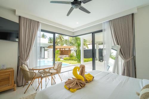 a bedroom with a bed with a banana on it at Villa Natali - Lamai in Amphoe Koh Samui