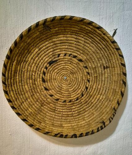 a wicker basket is hanging on a wall at Paglia d'Oro Luxury Flat in Lotzorai