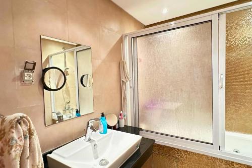 a bathroom with a sink and a large window at Ocean View Prestigia Residence in Sidi Bouqnadel