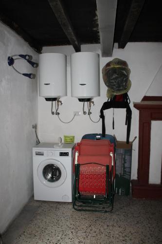 a small room with a washing machine and a lamp at PRIMA DEL CIELO - appartamento LAGO in Esino Lario