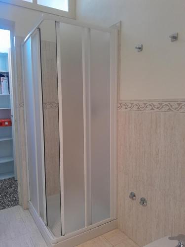 a shower with glass doors in a room at Piacenza centro in Piacenza