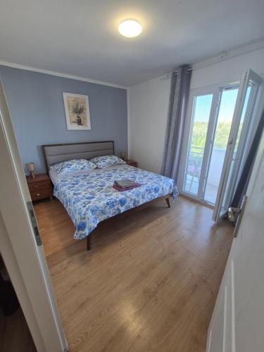 a bedroom with a bed and a large window at Mila in Olib
