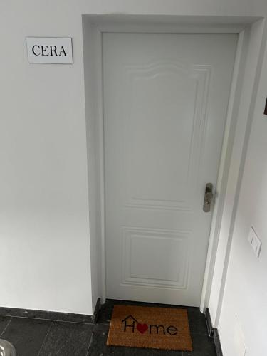 a white door in a room with a sign on it at Casa Bagacera "Cera" in Ingenio