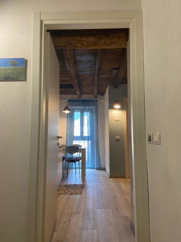 a hallway with a dining room and a table at PRIMA DEL CIELO - appartamento LAGO in Esino Lario
