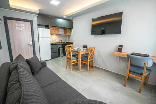 a living room with a couch and a table with chairs at Airport Bayrak Residences Trabzon in Trabzon