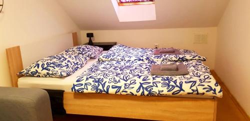 a bed with blue and white sheets and pillows at Zusy in Orebić