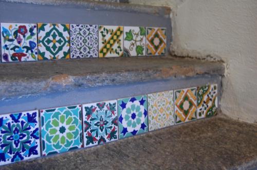 a bunch of different colored tiles on the stairs at PRIMA DEL CIELO - appartamento MONTI in Esino Lario