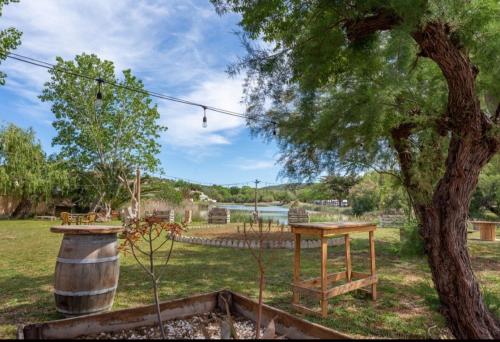 a picnic table and a tree in a field at Bungalow COSTA BRAVA in L'Escala