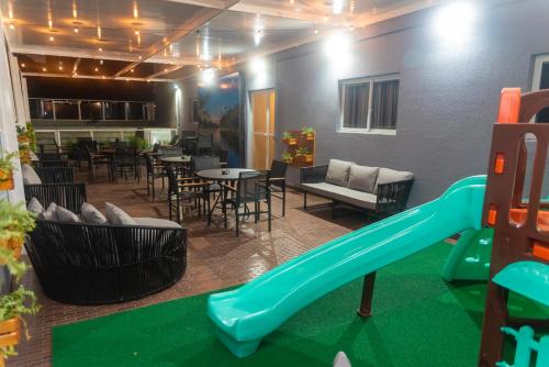 a playground with a slide and a table and chairs at eSuites Sorocaba in Sorocaba