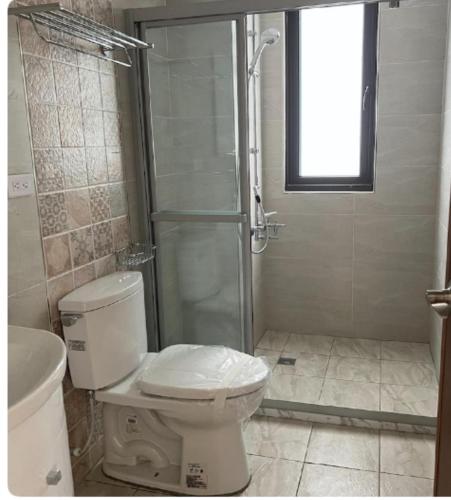 a bathroom with a toilet and a shower at Beautiful Villa in Shanhua