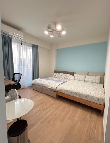 a bedroom with a bed and a table in it at Beautiful Villa in Shanhua