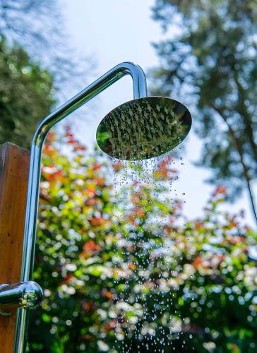 a shower head with water coming out of it at Ferienhaus Zissi in Wegberg
