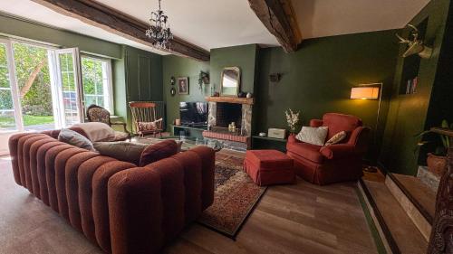 a living room with a couch and two chairs at La Maison de Cécile in Cahan