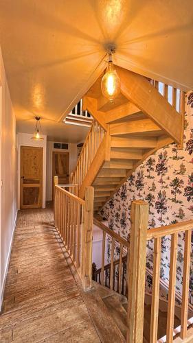 a wooden staircase in a house with a ceiling at La Maison de Cécile in Cahan