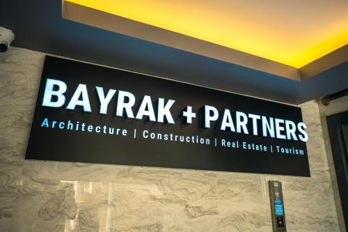 a sign on a wall that says bayak and partners at Airport Bayrak Residences Trabzon in Trabzon