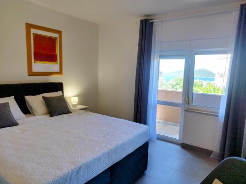 a bedroom with a bed and a sliding glass door at Apartments Davor in Drage