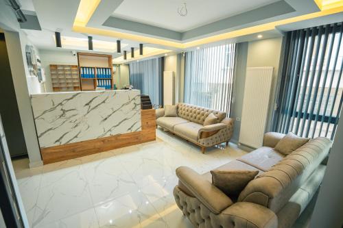 a living room with couches and a large marble screen at Airport Bayrak Residences Trabzon in Trabzon