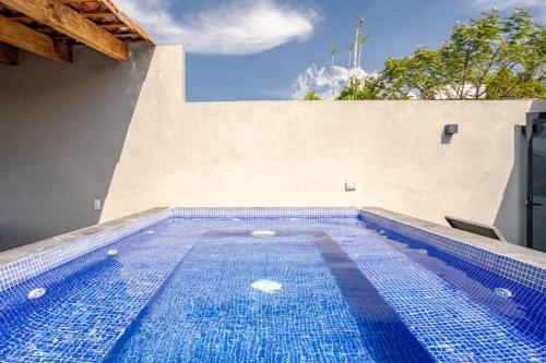 a large blue swimming pool in a house at LUXO Casa en Valle de Bravo con jacuzzi y espectacular vista al lago in Valle de Bravo