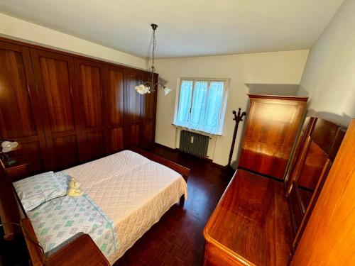 a bedroom with a white bed and a window at Moto-apartment in Boccaleone