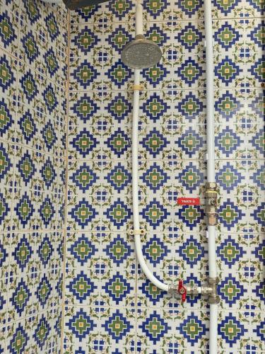 a bathroom with blue and white tiles on a wall at Merveilleuse Villa à Borj El Ras in Mahdia