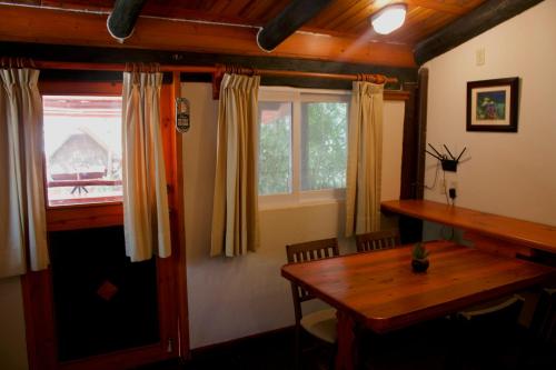 a dining room with a table and a window at The Diving Lodge Downtown in Puerto Morelos