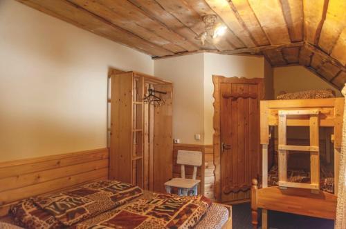 a bedroom with a bed and a wooden ceiling at Готель Згарда in Dragobrat