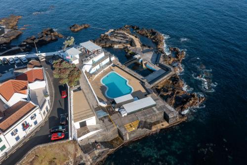an aerial view of a house on the water at Vista do Farol in Lagoa