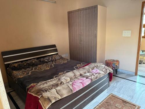 a bedroom with a bed in a room at Aadesh Home Private Floor With Rooftop in Faridabad