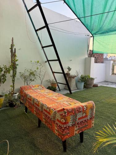 a ladder sitting on top of a bench under a tent at Aadesh Home Private Floor With Rooftop in Faridabad