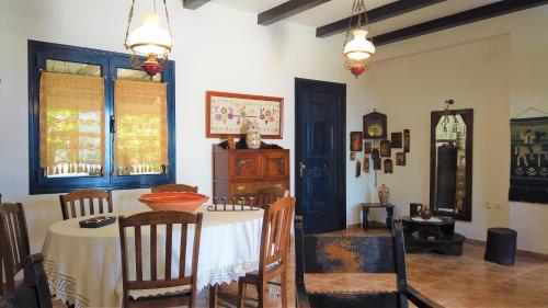 a dining room with a table and chairs in a room at Gianni's village home in Aegina Town